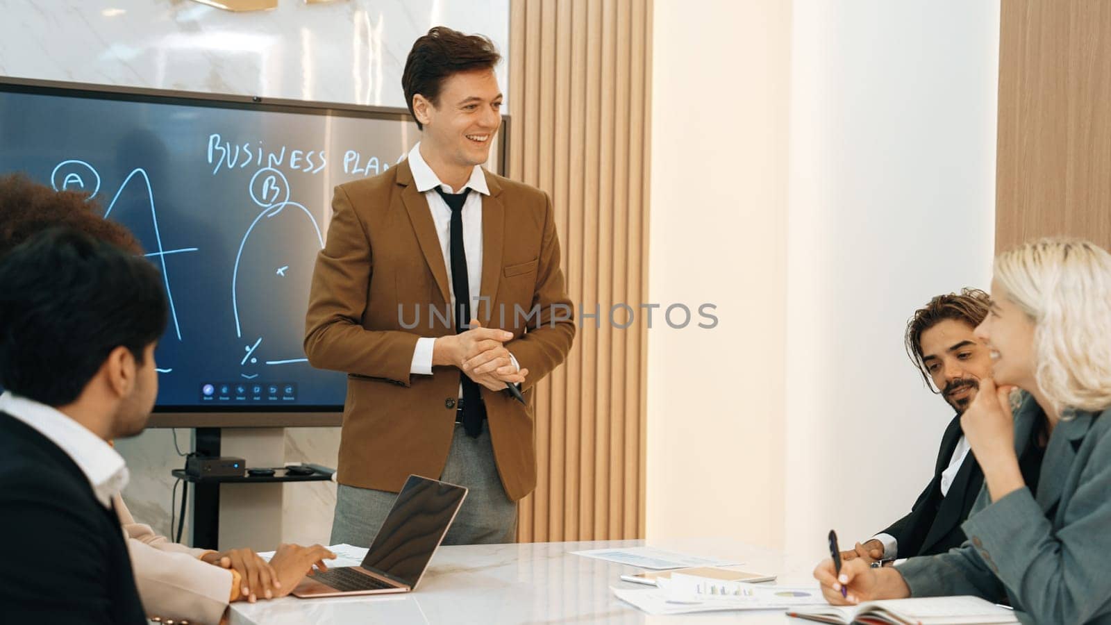 Presentation in ornamented meeting room with business professionals attending to project development drafting plan. Conference meeting with CEO present plan for investor and colleague with new project