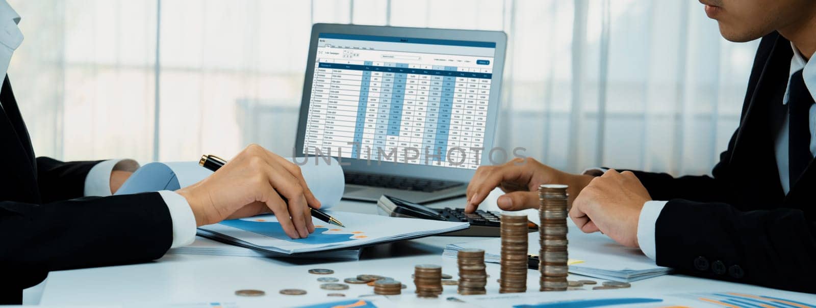 Corporate accountant use accounting software on laptop to calculate and maximize tax refunds and improve financial performance with business investment concept of growth stack coin in panorama. Shrewd