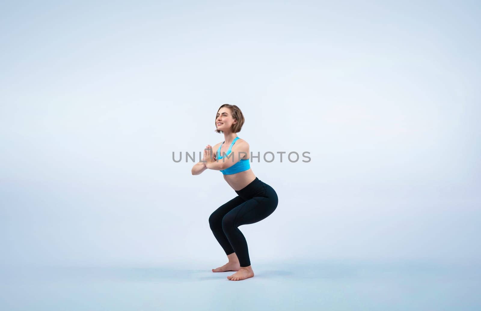 Full body length gaiety shot athletic and sporty woman doing healthy and meditative yoga exercise workout posture on isolated background. Healthy active and body care lifestyle