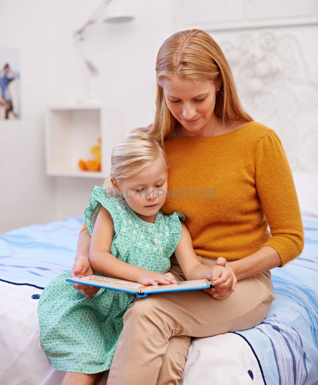 Mother, child and kids book for bed in bedroom at family home with fantasy story for development. Love, care and support of a mom with a young girl together with bonding and reading for education by YuriArcurs