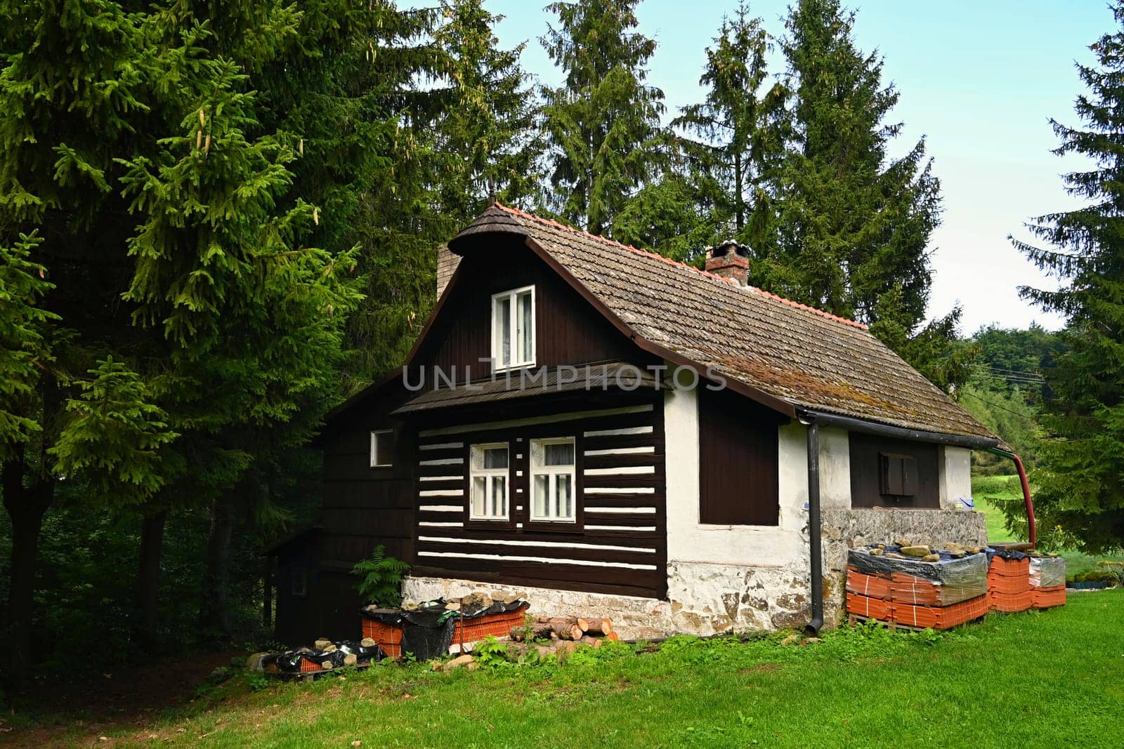 Beautiful old traditional house in the mountains in the Czech Republic. Cottage in nature.