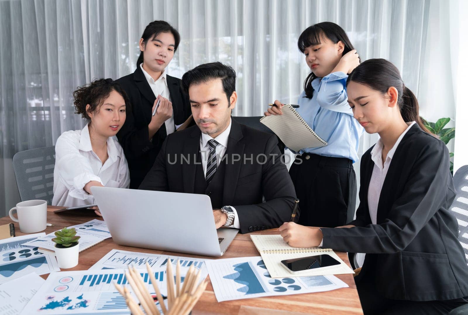 Diverse group of business analyst team analyzing financial data report paper on office table. Chart and graph dashboard by business intelligence analysis for strategic marketing planning Habiliment