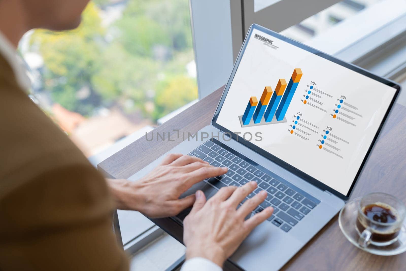 Top view of smart businessman hand searching, typing,analyzing data by using laptop. Closeup image of manager hand working with laptop displayed financial graph and business data. Closeup. Ornamented.