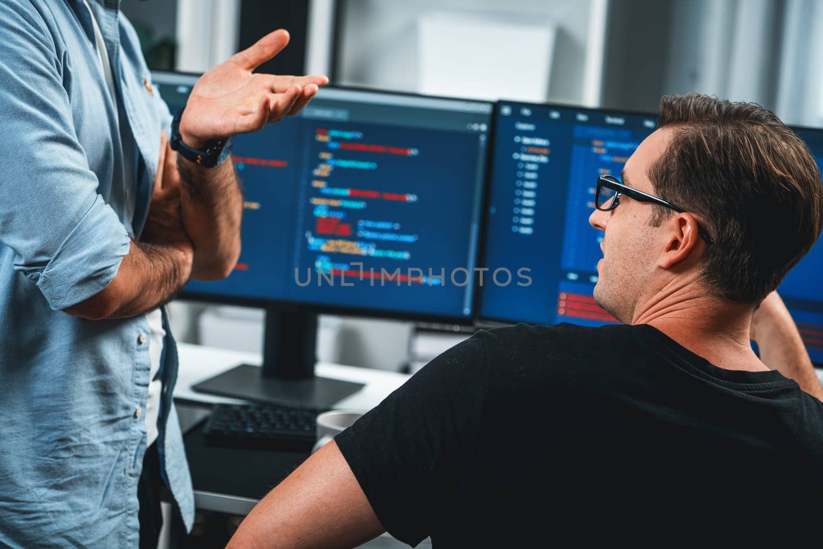 IT developers discussing online software development information on pc screen, creating program coding for latest version application on website. Concept of brainstorming firmware updated. Sellable.