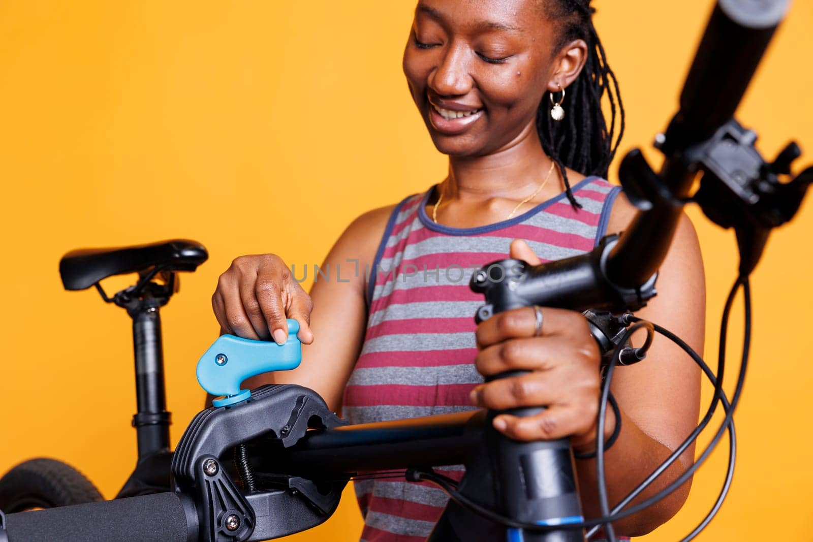 Black Woman Repairing Bicycle Frame by DCStudio