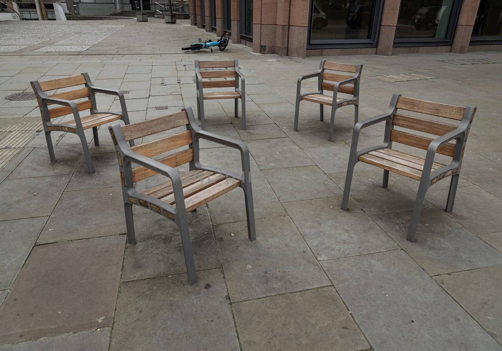 London, UK - Feb 27, 2024 - These street chairs look casually placed, but they're screwed into the floor for People can comfortably sit together. Contemporary chairs, Furniture group, Copy space, Selective focus.