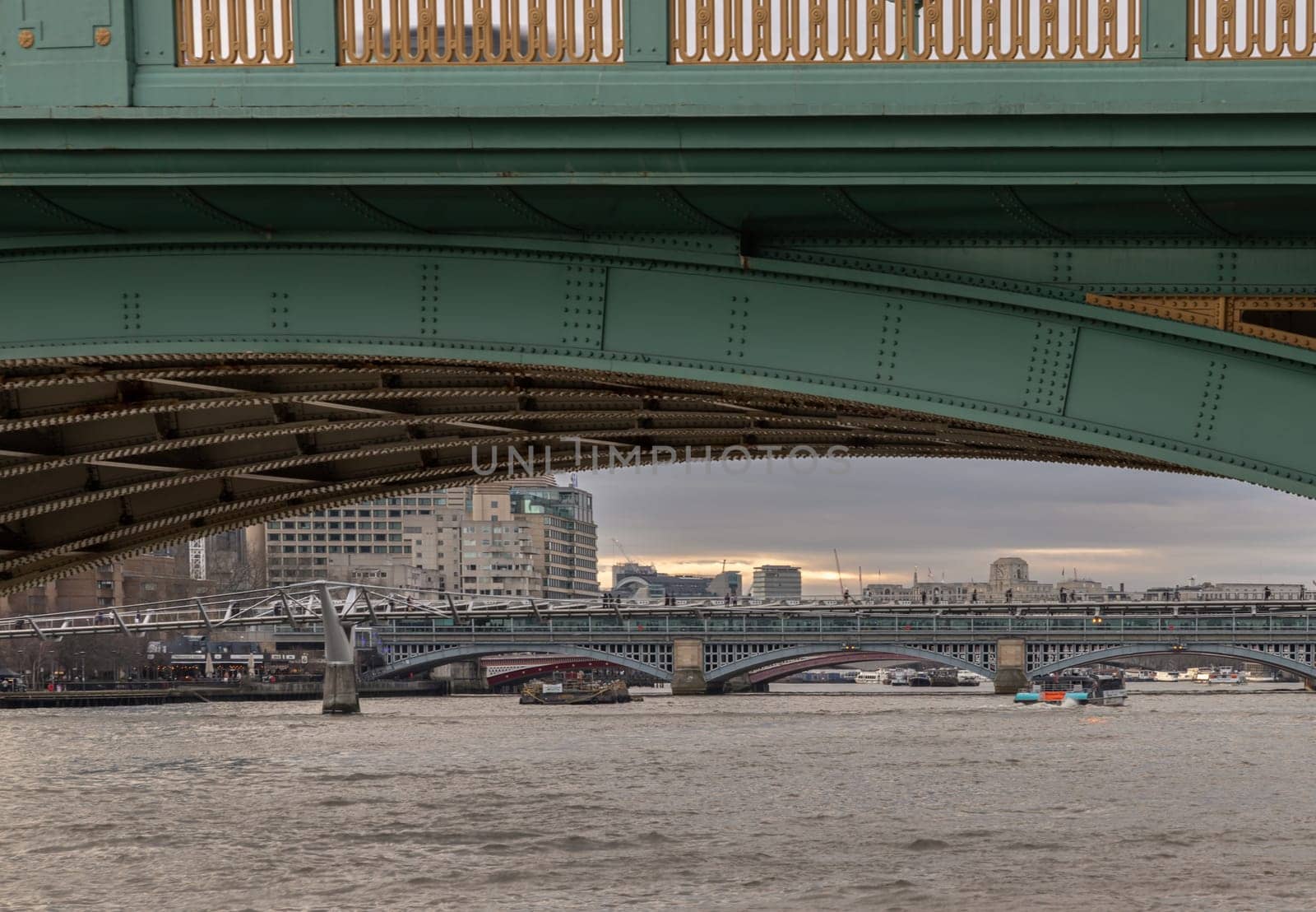 View of Blackfriars Bridge and Millennium Bridge Looking through underneath Southwark Bridge. by tosirikul