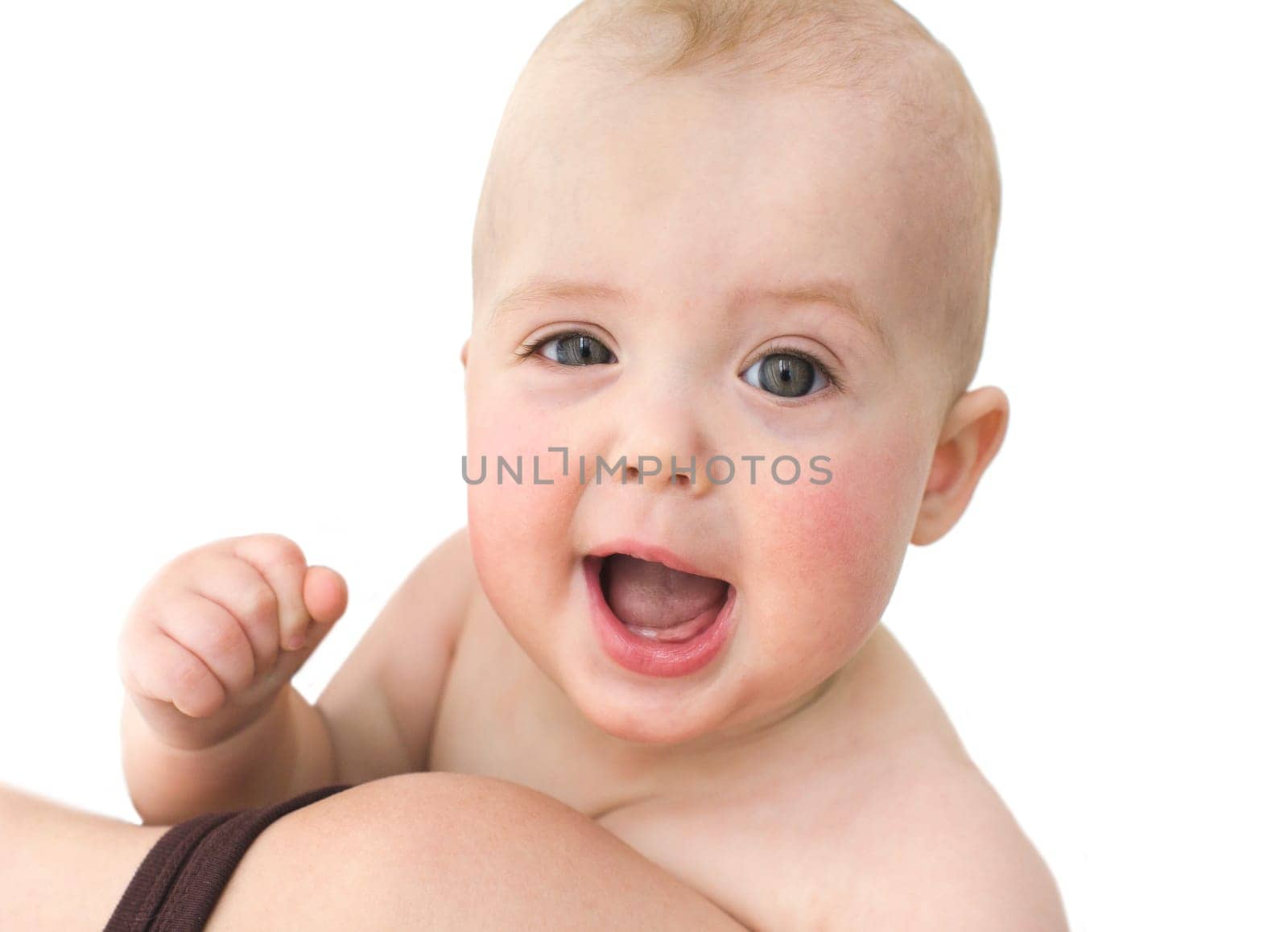 Beautiful smiling cute baby loocing at camera. The fun baby is happy to wink and clenching a fist at mom's hands, close-up, isolated