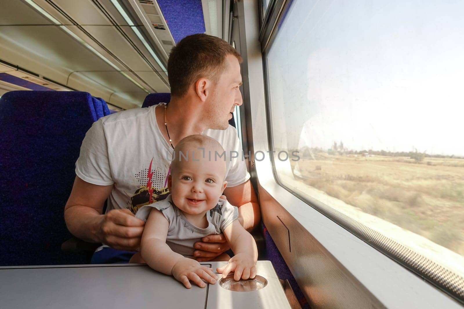 Man father travelling with his little son by train by Demkat