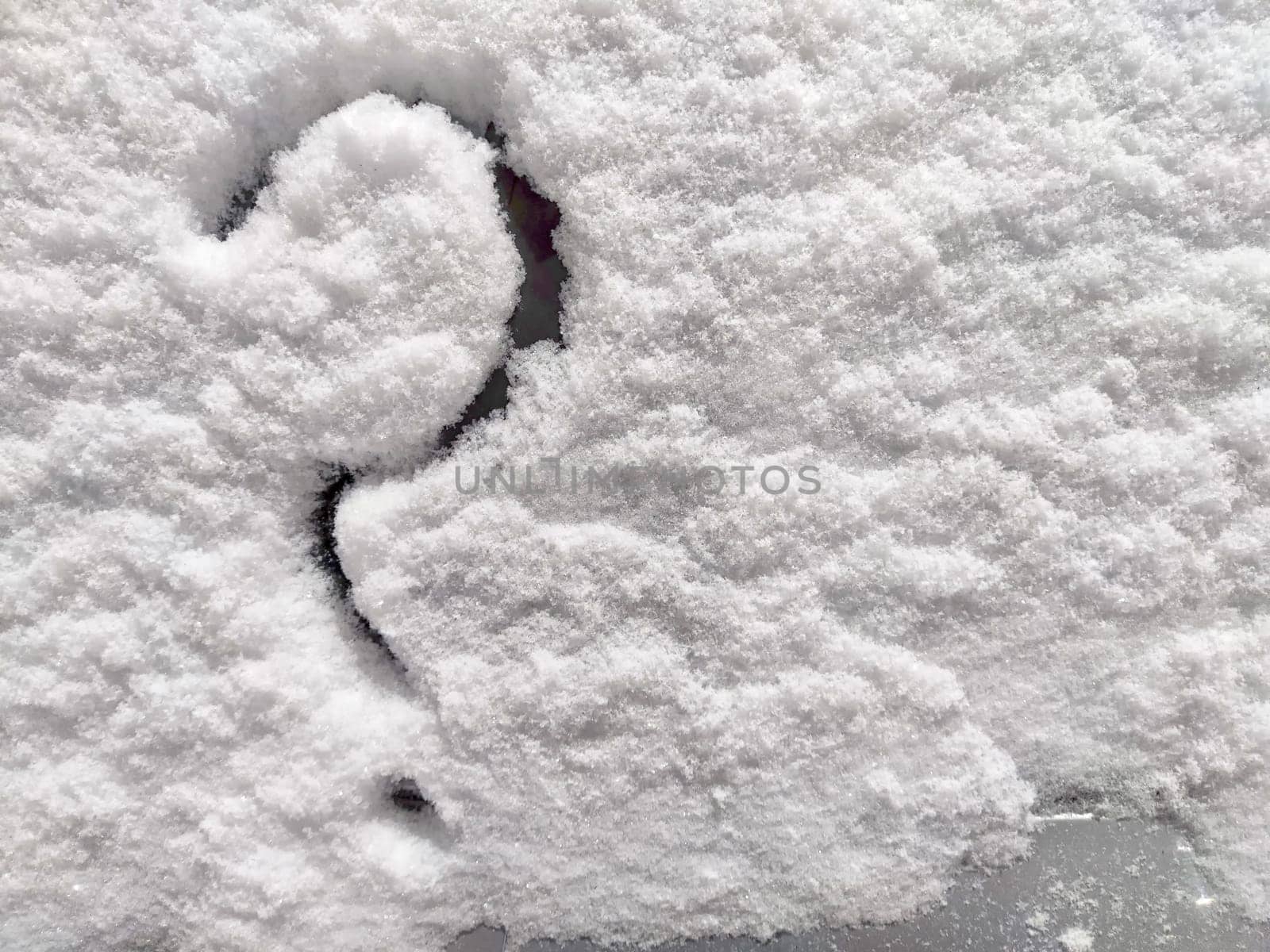 Question mark written in the snow. The cold frosty texture of the snow and the question mark. Background, place for text, copy space