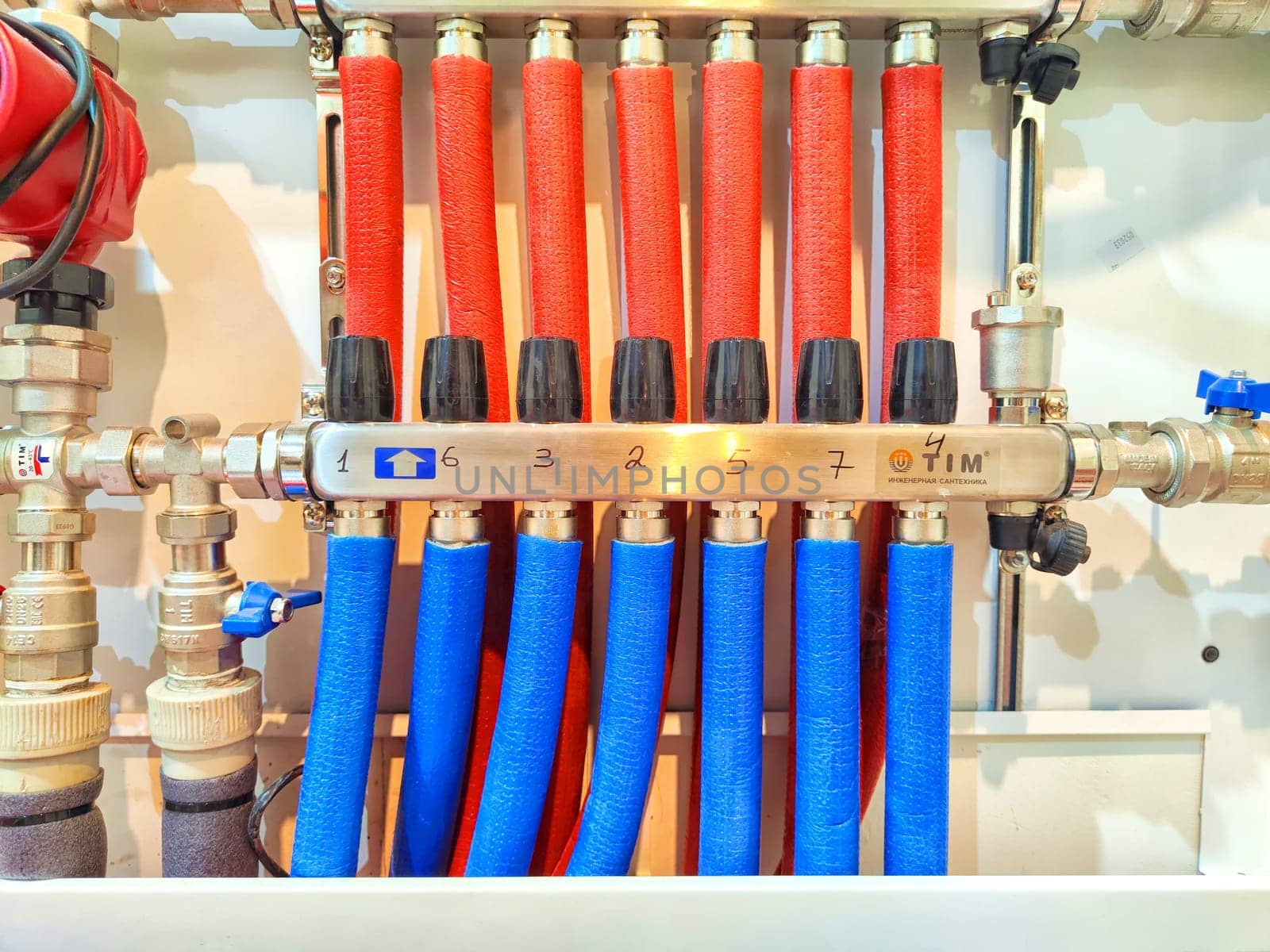 Network of Pipes Attached to Wall. Multiple interconnected pipes securely attached to a wall in functional and organized arrangement