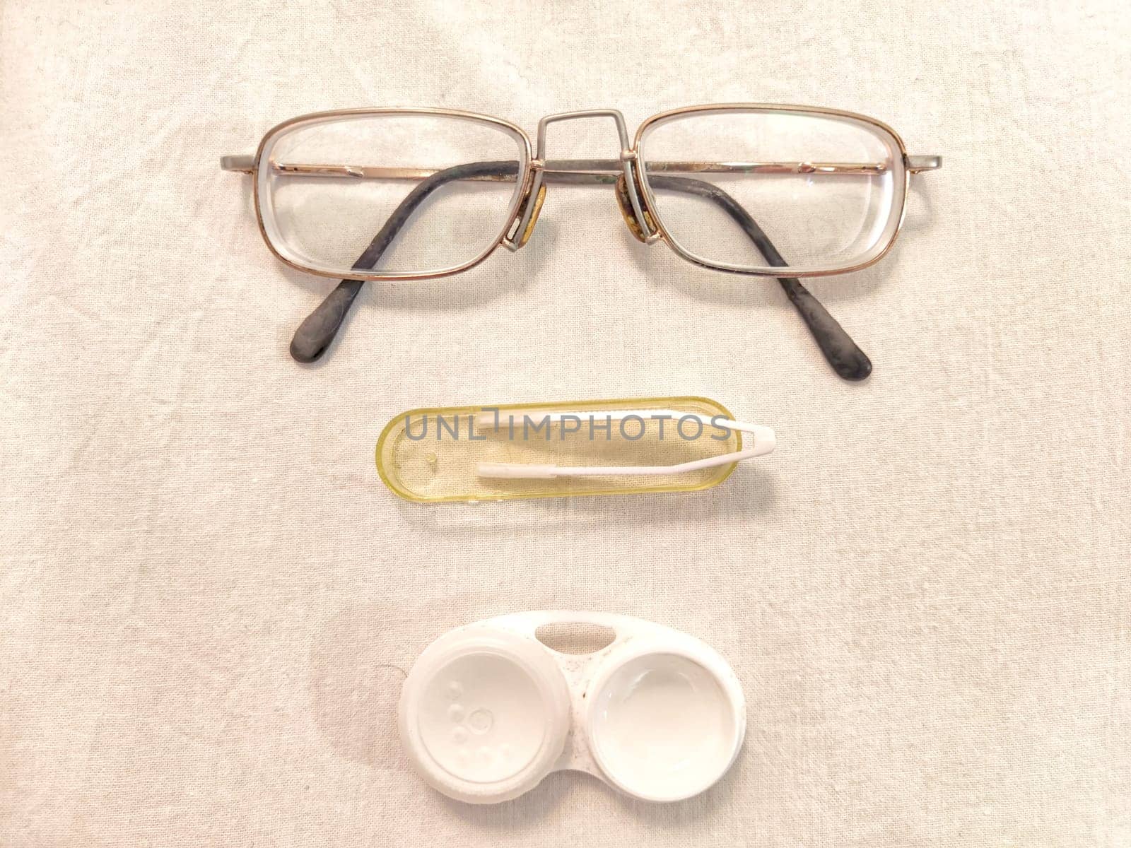 Set for contact lenses with a container, forceps, glasses. The concept of correcting myopia. Contact lens care, cleaning, health. Background, copy space