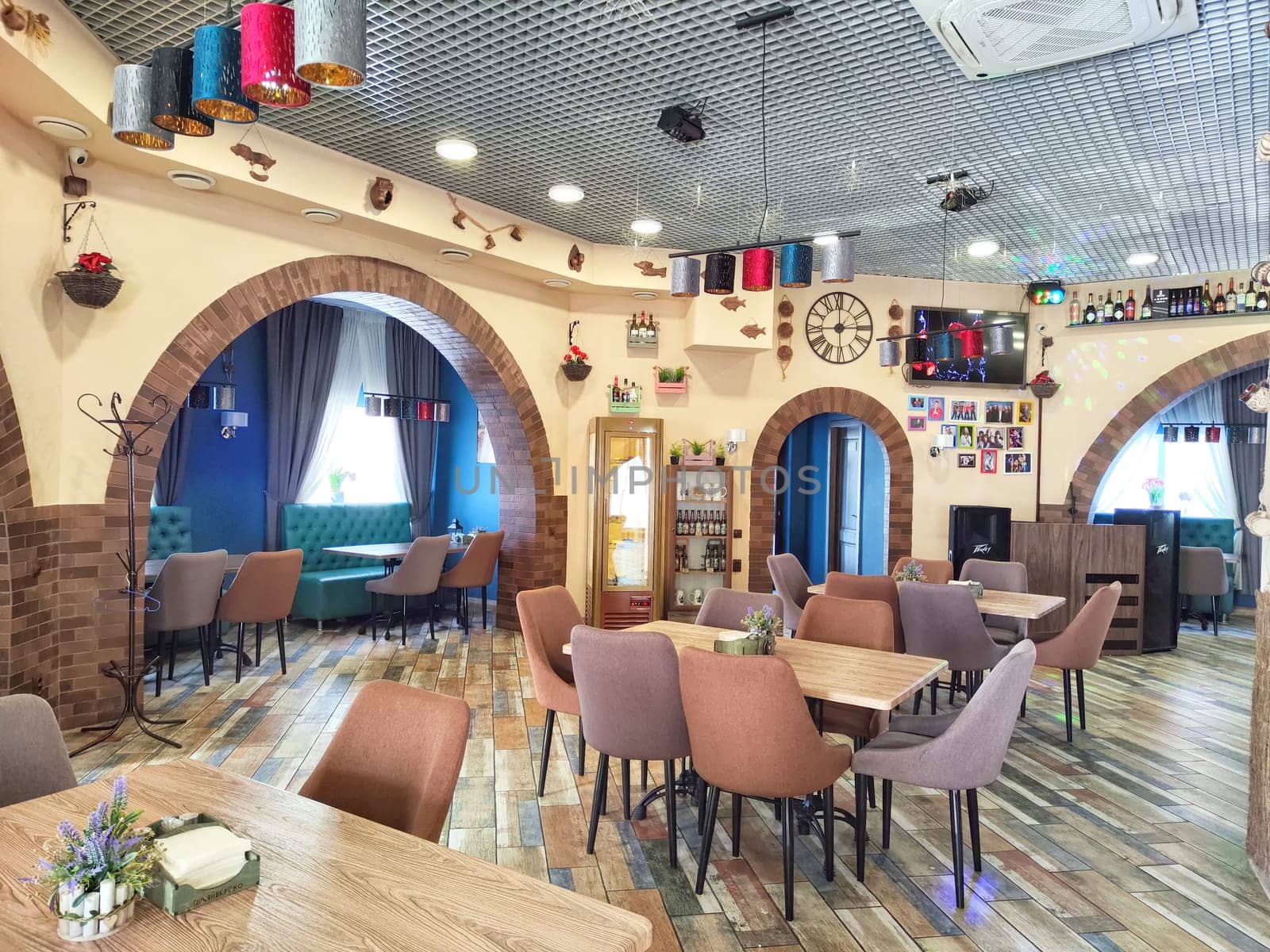 Elabuga, Russia - February 25, 2024: Cozy European-Style Cafe Interior During Daytime. Warm and inviting cafe setting with modern furnishings