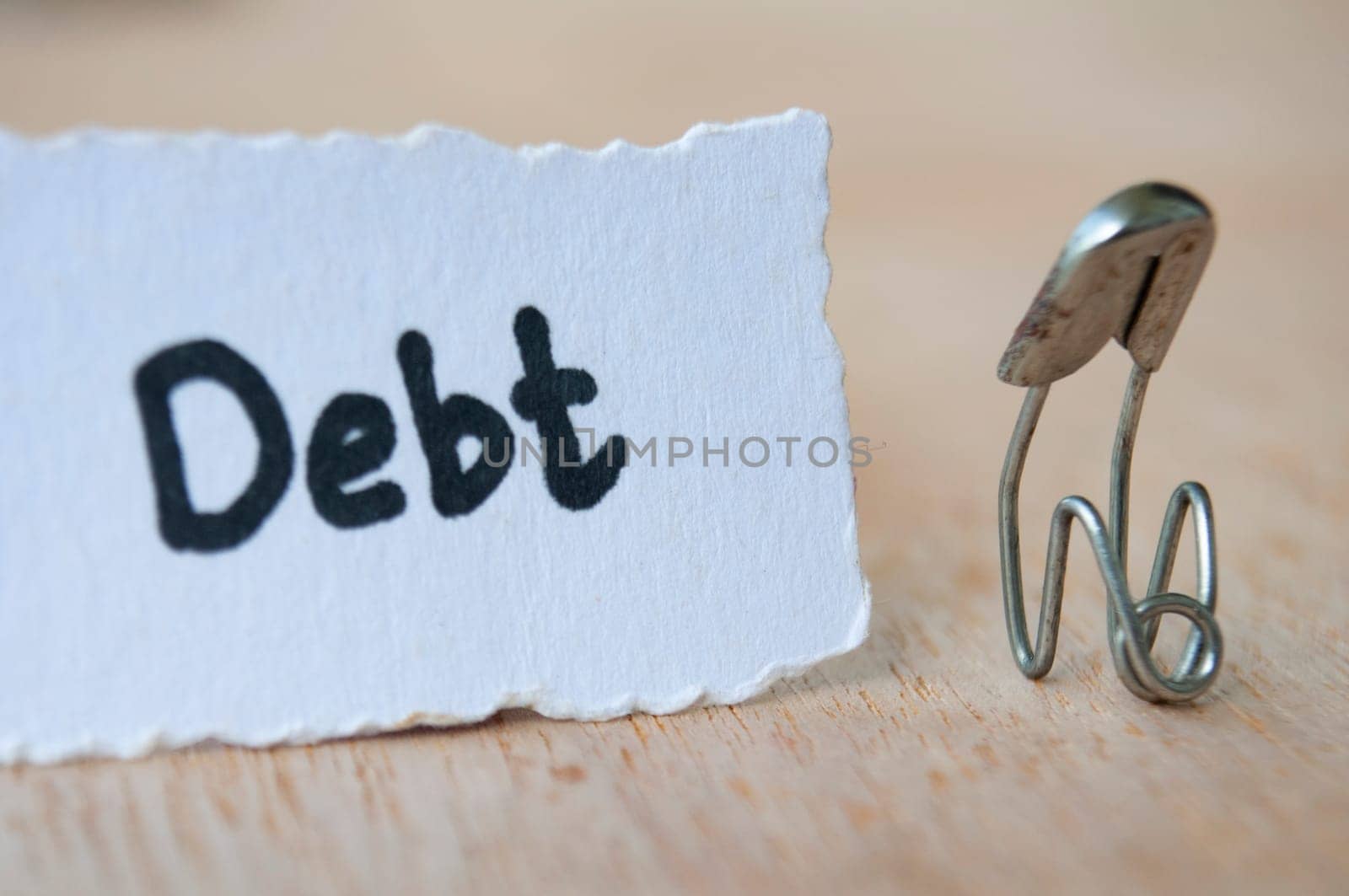 A pin representing a stressful person being having too many debts.