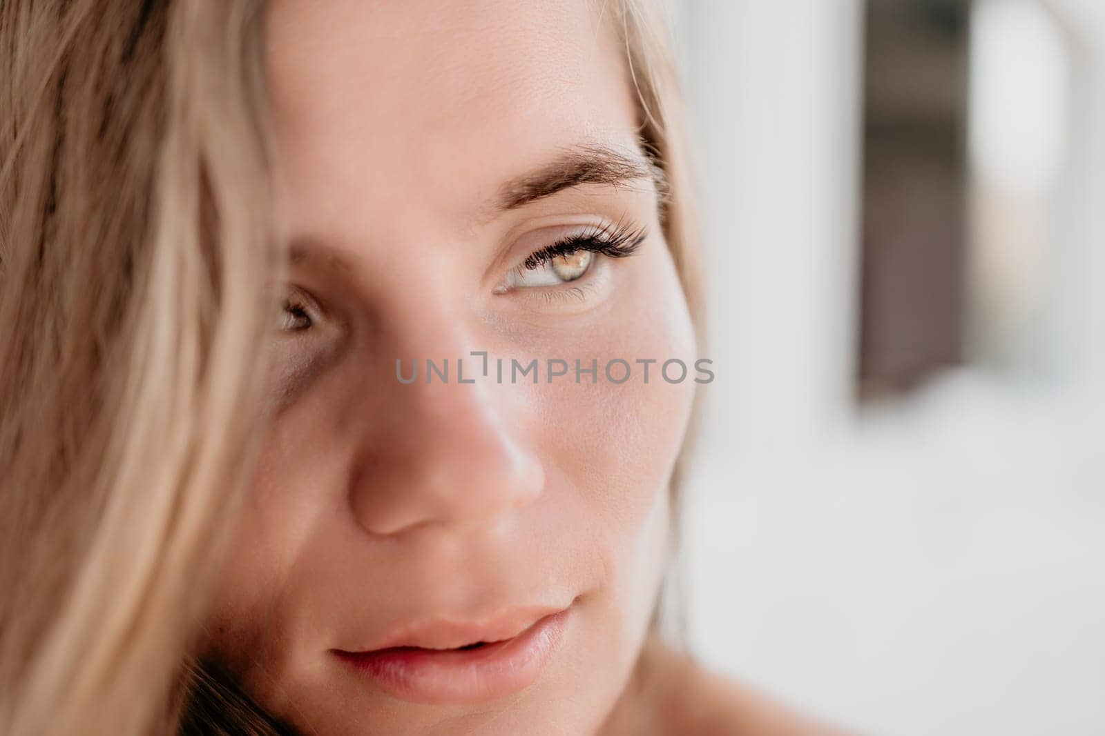 Happy woman portrait in cafe. Boho chic fashion style. Outdoor photo of young happy woman with long hair, sunny weather outdoors sitting in modern cafe