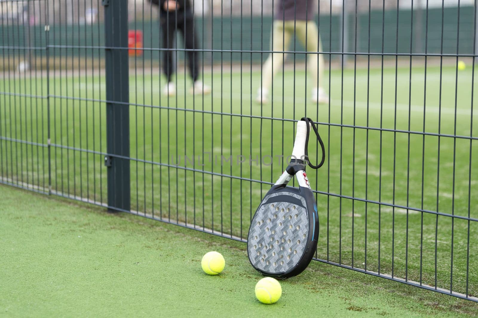 Paddle tennis racket, ball and net on the grass . High quality photo
