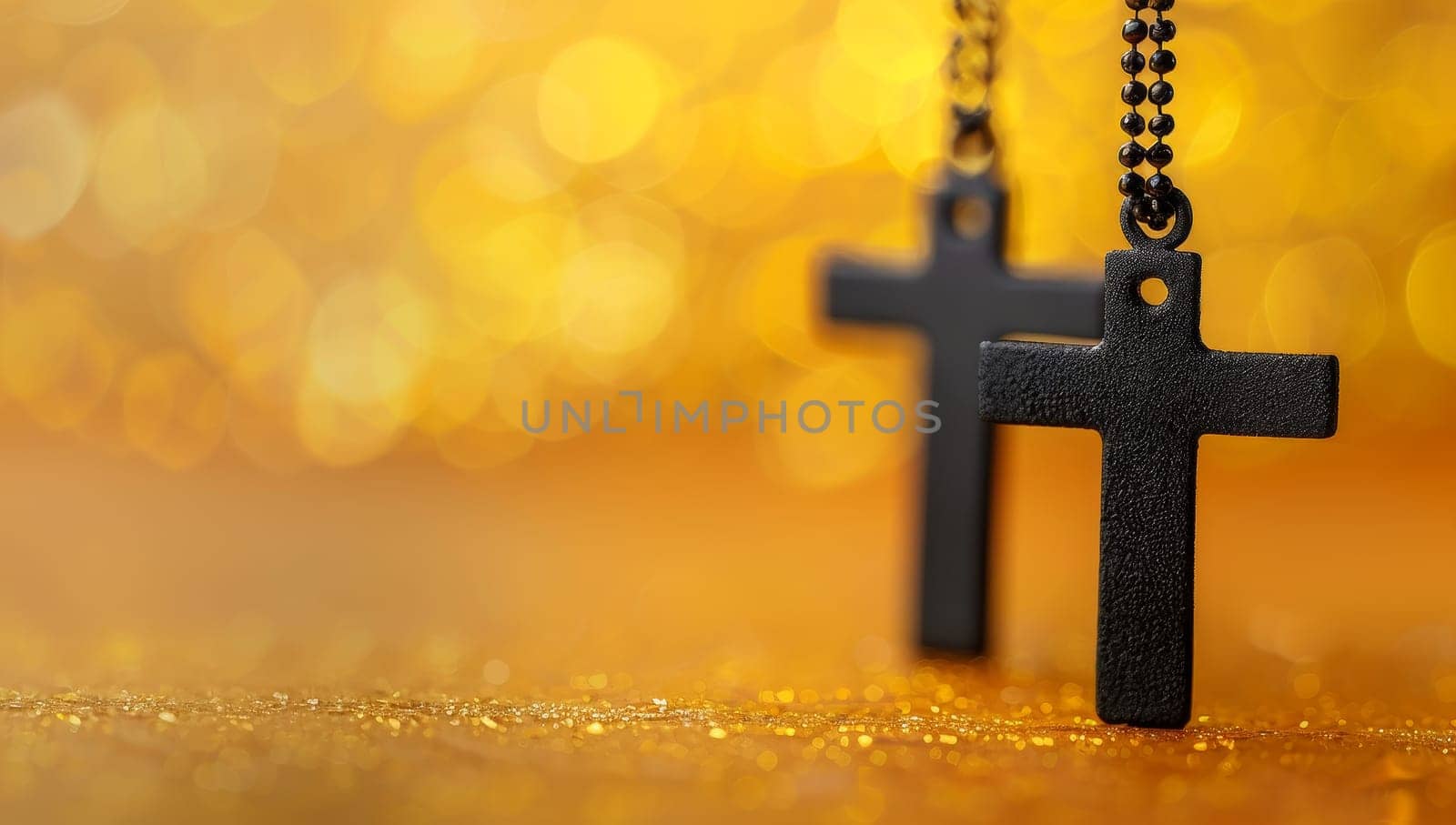Black Christian cross on golden bokeh background with copy space.