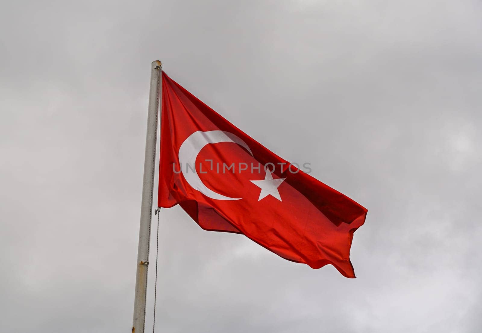 Turkey flag against cloudy sky in winter