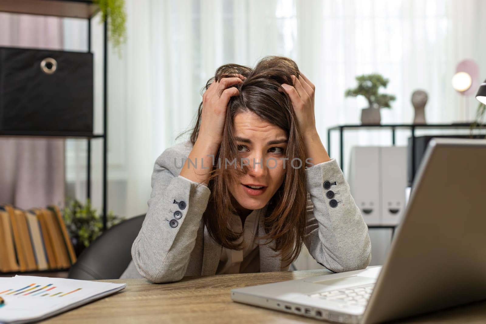 Tired sleepy young business woman sitting at home office desk with laptop overworked lazy bored lady worker feel fatigue exhausted of work deprived. Exhausted workaholic freelancer workaholic girl
