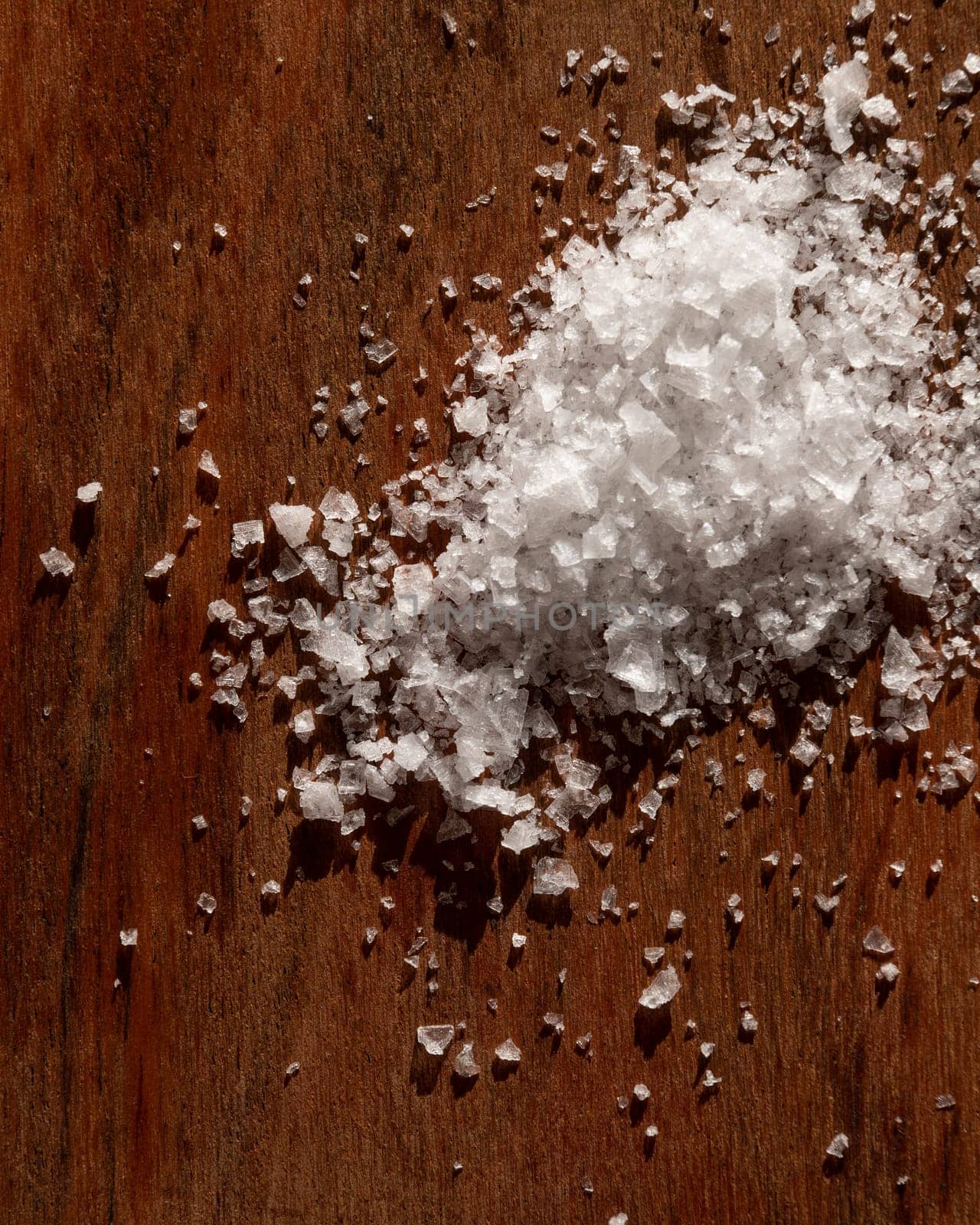 A Pile Of Salt Is On A Wooden Table by apavlin