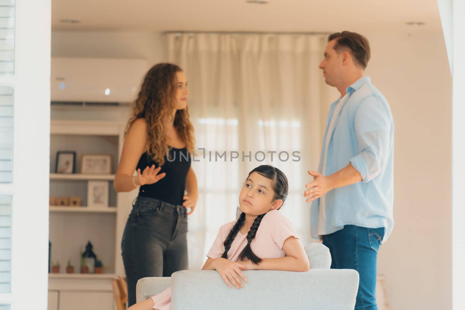 Young girl trapped in the middle of tension by her parent argument. Synchronos by biancoblue