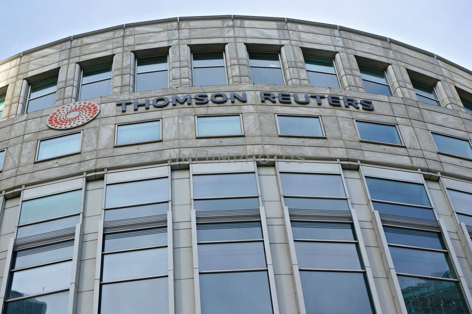 London, United Kingdom - February 03, 2019: Sun shines on Thomson Reuters offices building at Canary Wharf in UK capital. TR Group is Canadian multinational mass media and information firm by Ivanko