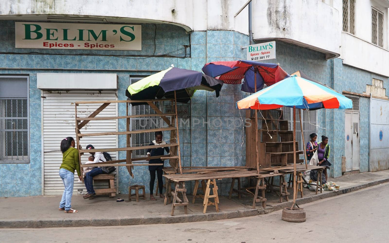 Antananarivo, Madagascar - April 24, 2019: Unknown Malagasy women setting up their stall at market in the morning, there are not many shops and stuff is usually sold directly on streets at Madagascar