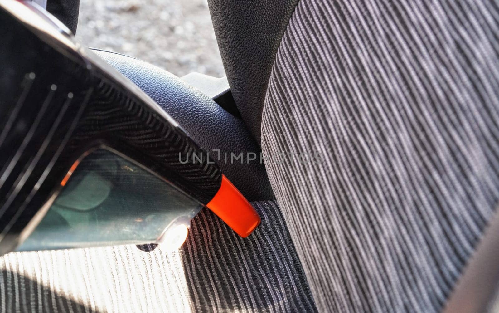 Car interior - seats, cleaned from dust with small orange portable vacuum cleaner by Ivanko