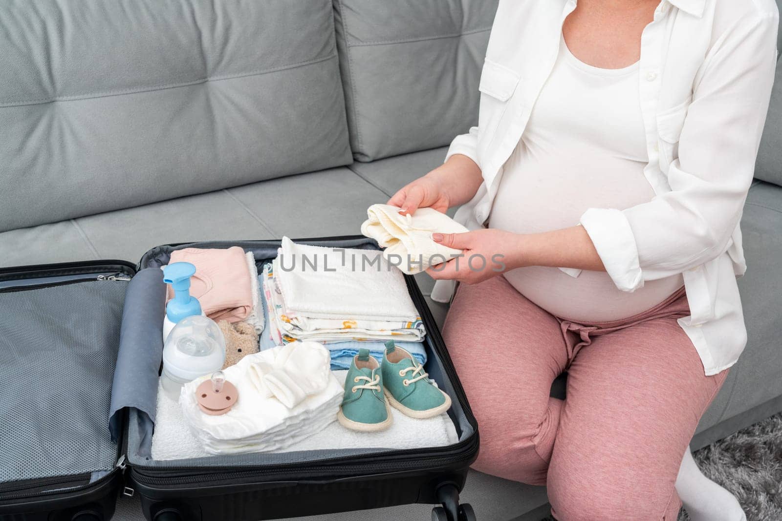 Things for the maternity hospital are packed by a pregnant woman.