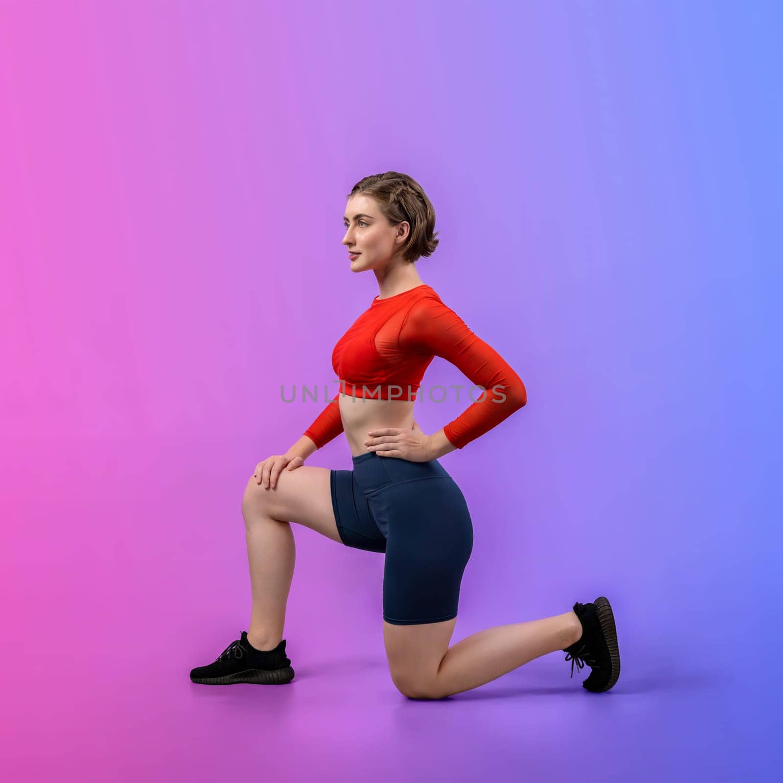 Full body length gaiety shot athletic and sporty young woman in fitness exercise posture on isolated background. Healthy active and body care lifestyle.