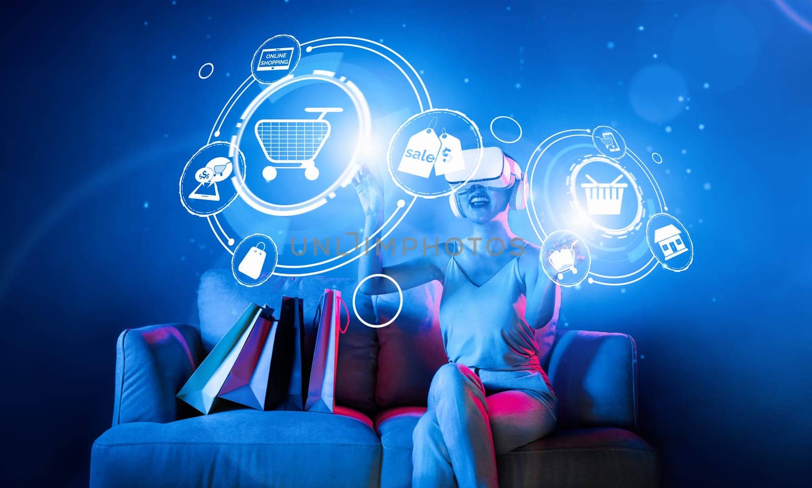 Smart female sitting on sofa while wearing VR headset connecting metaverse, future cyberspace community technology. Elegant woman enjoy open interface online store menu shop product. Hallucination.