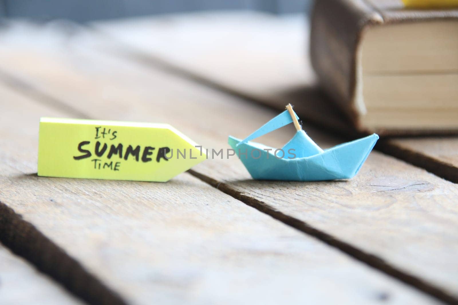 Its Summer Time concept. Origami paper boat and text.