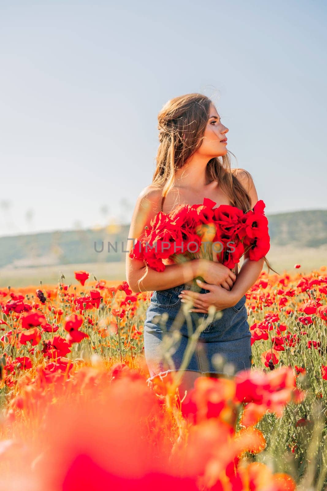 Woman poppies field. portrait happy woman with long hair in a poppy field and enjoying the beauty of nature in a warm summer day. by Matiunina