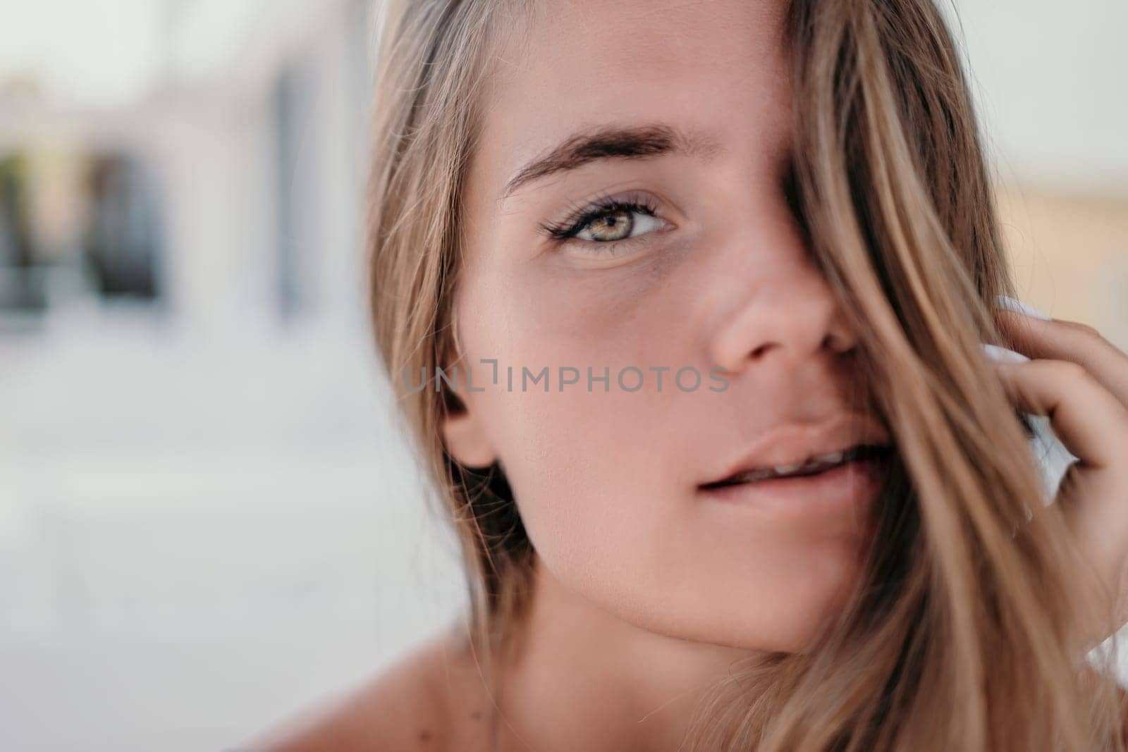 Happy woman portrait in cafe. Boho chic fashion style. Outdoor photo of young happy woman with long hair, sunny weather outdoors sitting in modern cafe