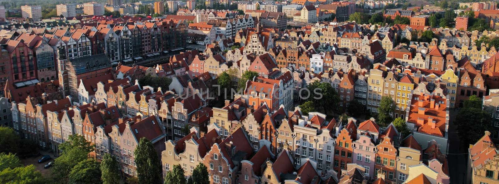 Beautiful panoramic architecture of old town in Gdansk, Poland at sunrise. Aerial view drone pov. Landscape cityscape City from Above. Small vintage historical buildings Europe Tourist Attractions travel destination in Gdansk