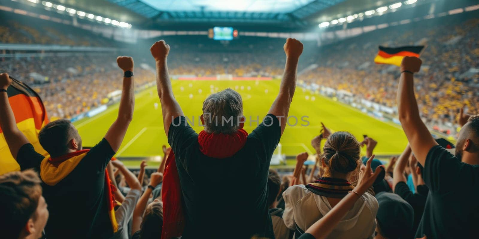 A fan at a world competition event raises his arms in the air, enjoying the fun and energy of the crowded stadium. AIG41