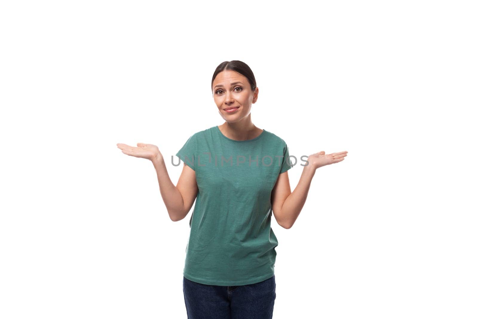 30 year old slender European brunette woman with ponytail hairstyle dressed in green t-shirt has doubts by TRMK