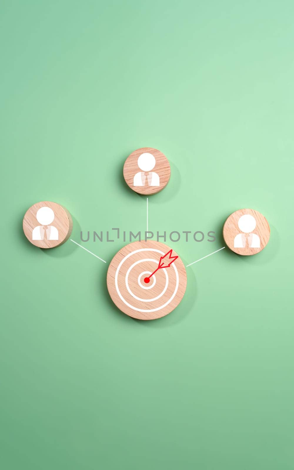 Circular wood with printed target icons and business symbols on light blue background, business goals and objectives concept, business competition, Customer relationship management concept.