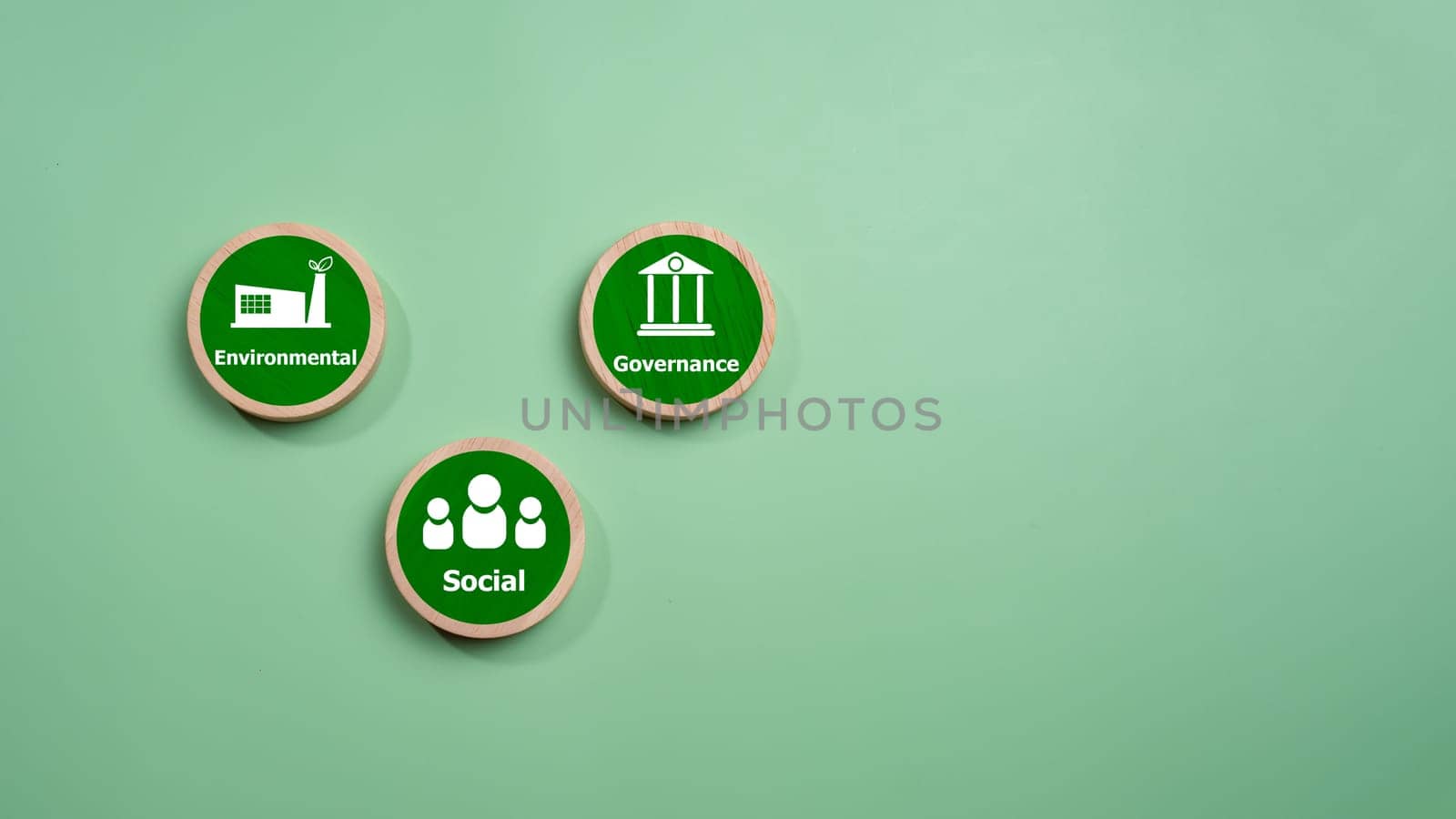 ESG concepts for sustainable environment, society and governance Businesses are environmentally responsible, A circular wooden board with the abbreviation ESG printed on a green background.