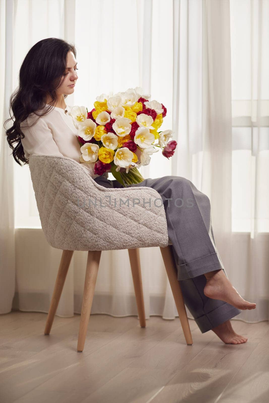 woman in the white shirt with flowers tulips by erstudio