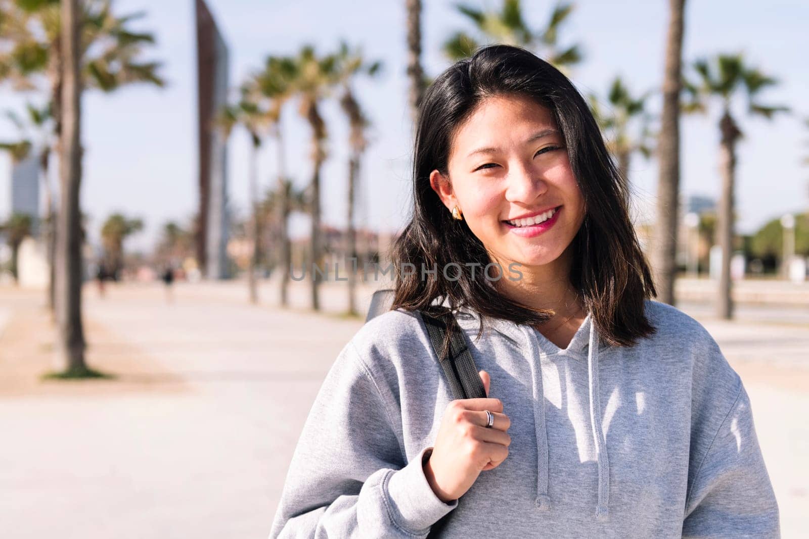 portrait of young asian college girl dressed in casual clothes smiling looking at camera, student lifestyle concept, copy space for text