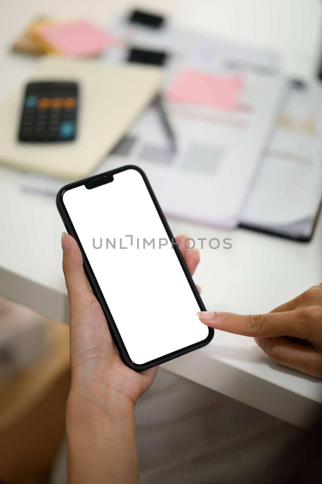 Close up of woman touching blank empty screen of mobile phone with finger.