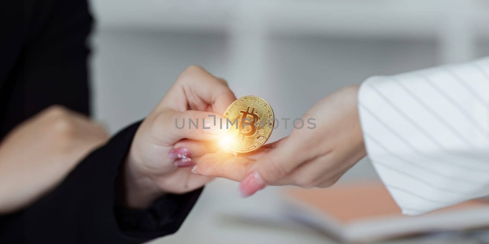 Business woman handing crypto coins to partner. cryptocurrency investment concept by itchaznong