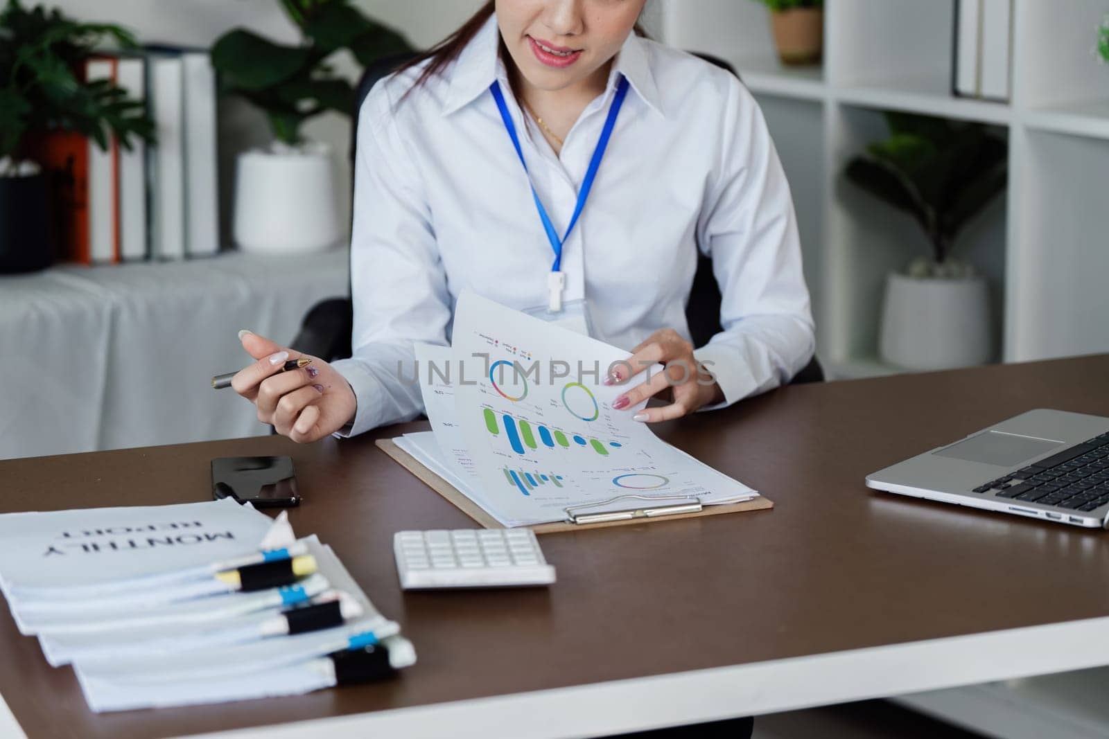 Businesswoman analyzing marketing strategy with document about company profit.