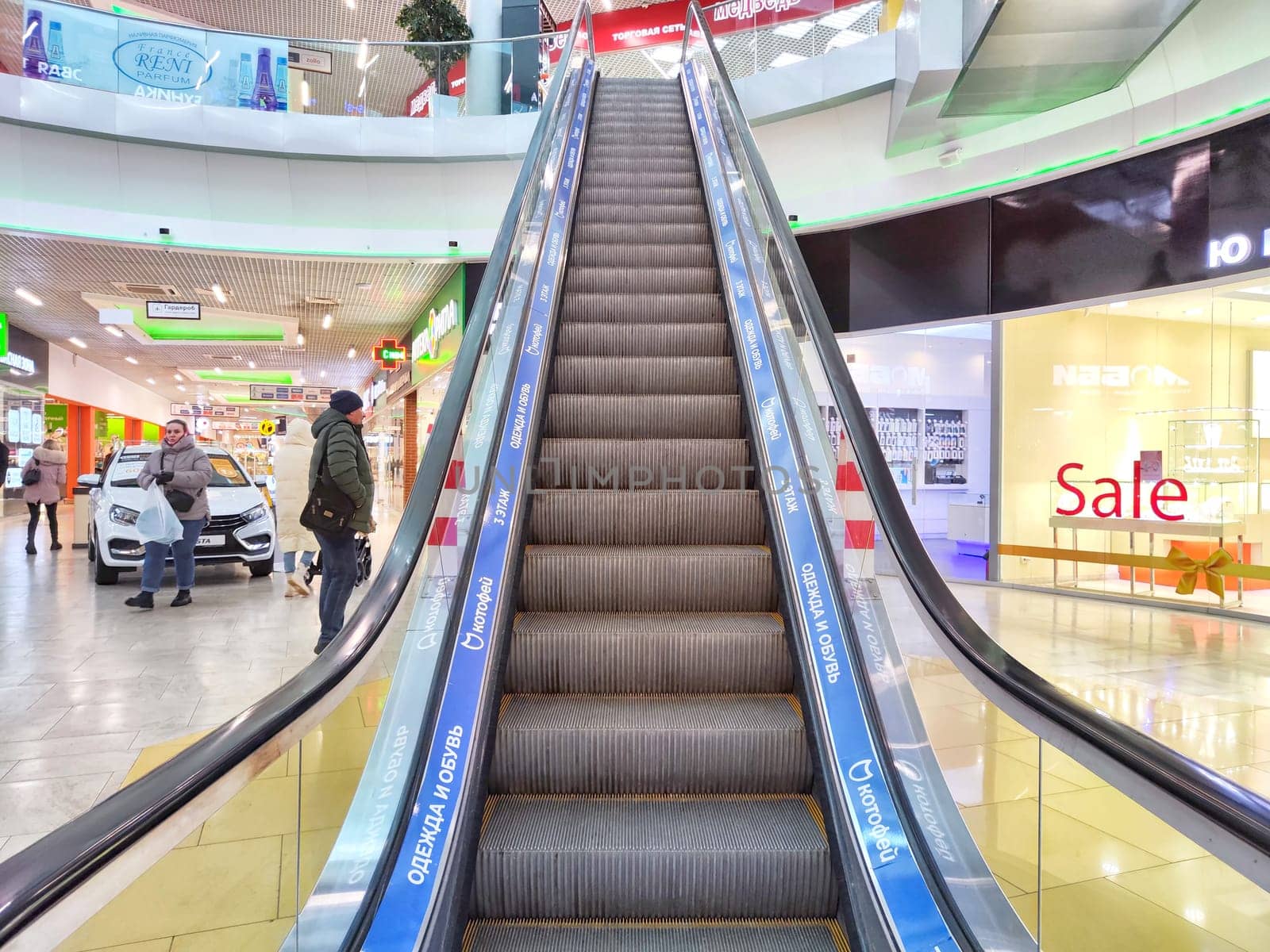 Arkhangelsk, Russia - February 28, 2024: Escalator in Modern Shopping Mall. Big Escalator inside a vibrant shopping center