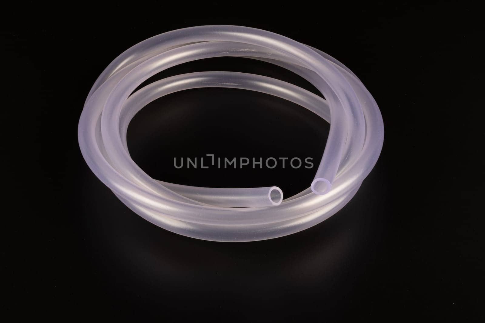 transparent plastic tube coil on black background by z1b