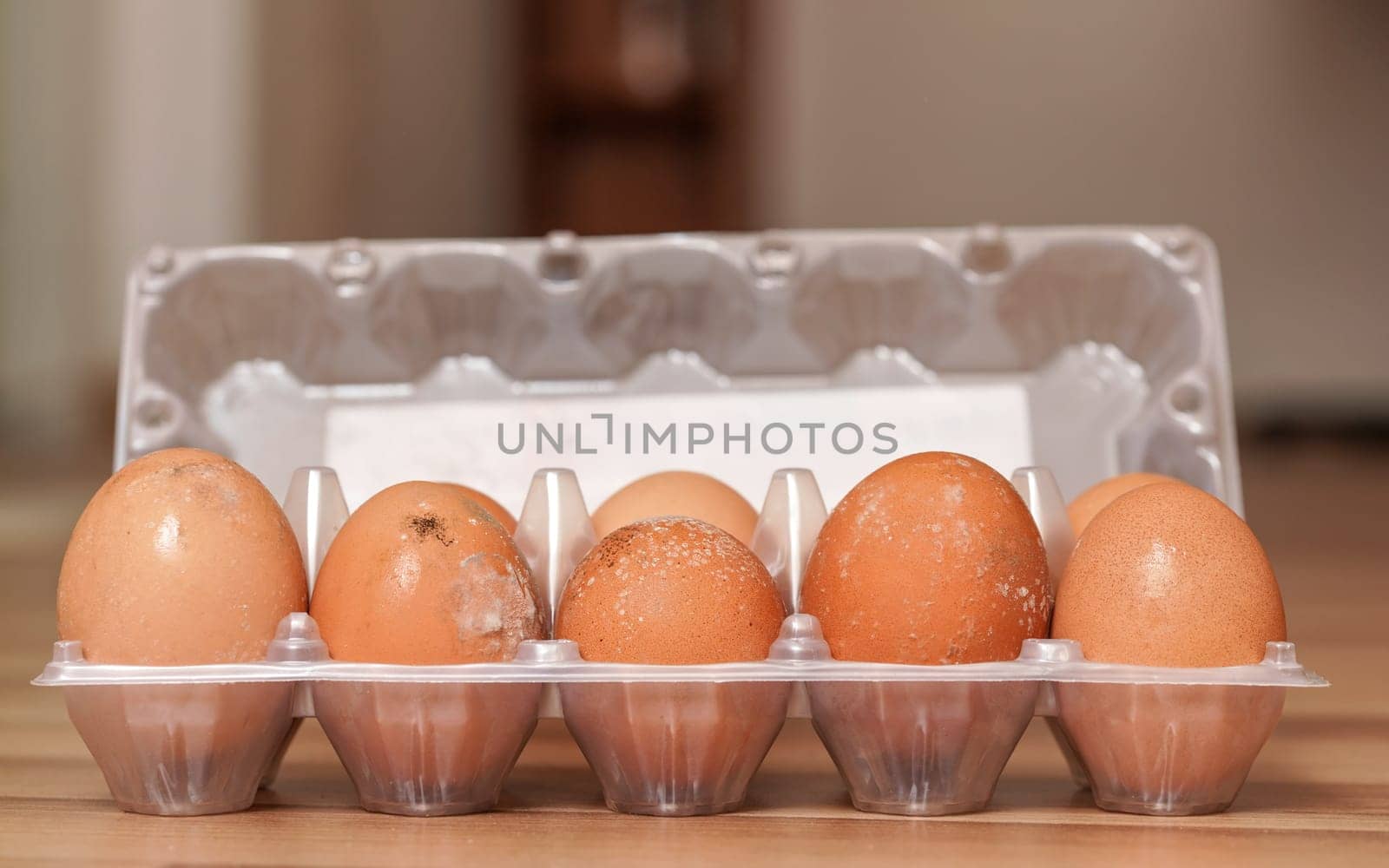 Ten mouldy eggs in plastic packaging, mildew growing on shell as they were stored improperly in wet fridge for long by Ivanko