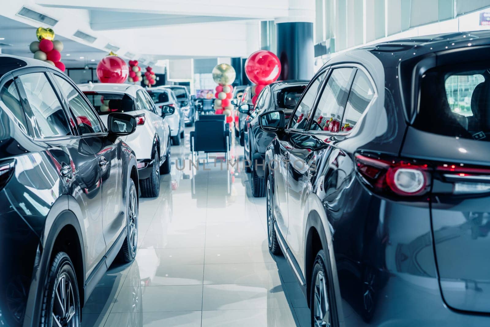 Selective focus grey car parked in luxury showroom. Car dealership office. New car parked in modern showroom. Car for sale and rent business concept. Automobile leasing and insurance background. by Fahroni