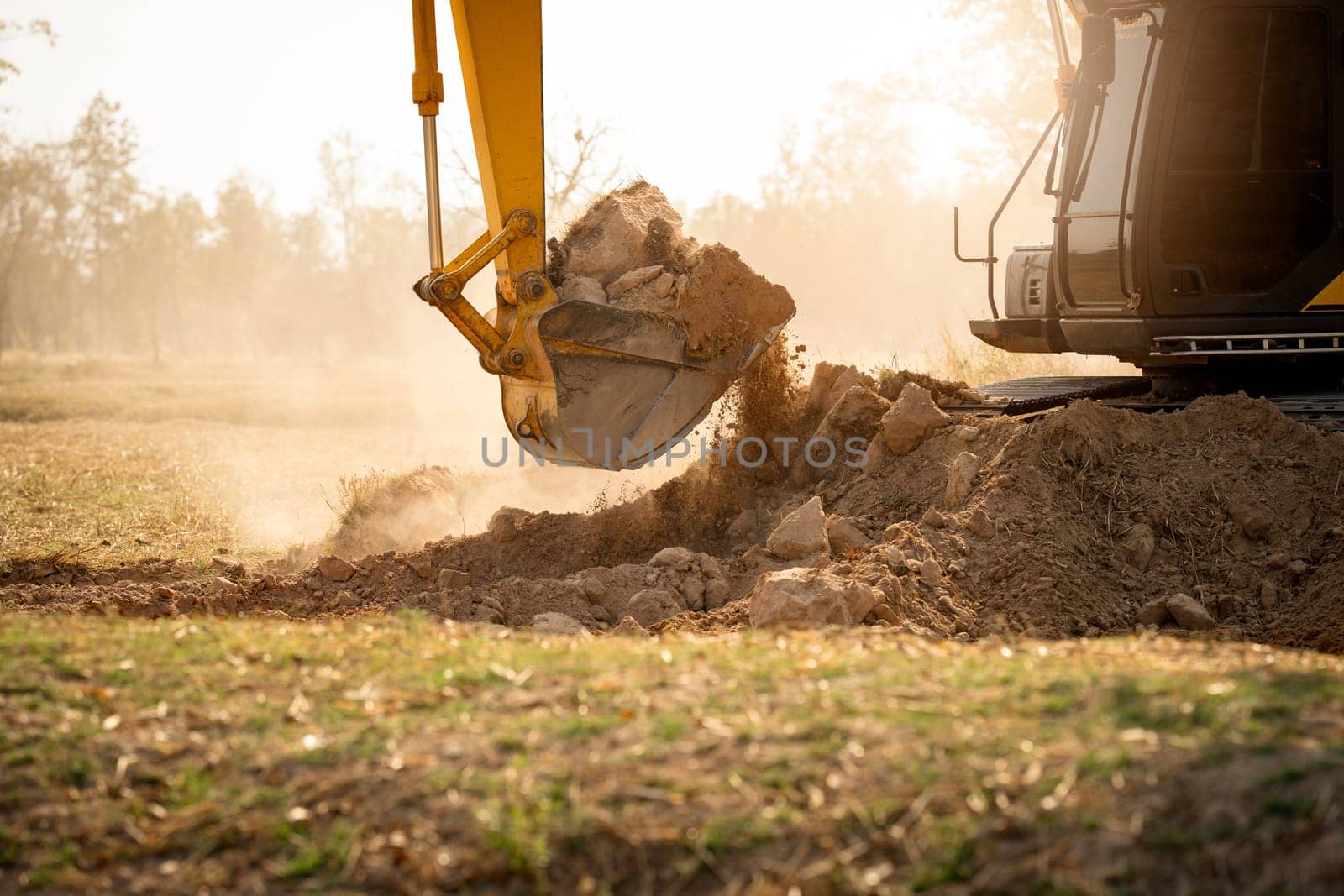 Backhoe working by digging soil at construction site.  Crawler excavator digging on demolition site. Excavating machine. Earth moving machine. Excavation vehicle. Construction business. by Fahroni