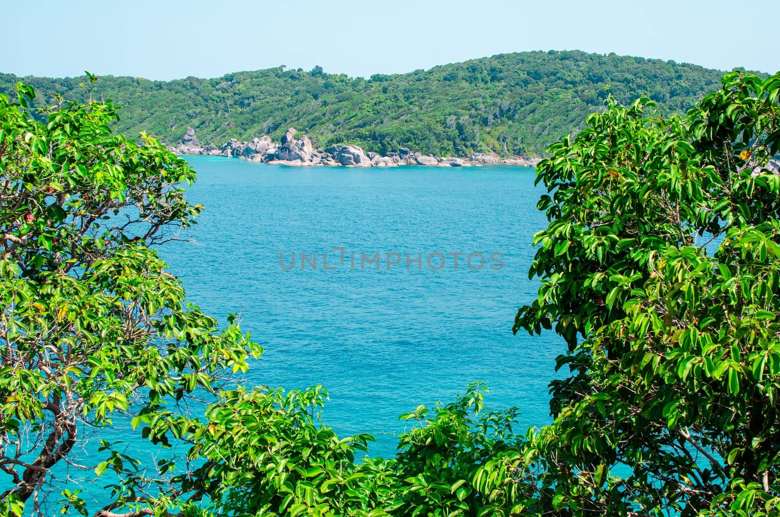 Tropical islands of ocean blue sea water and white sand beach at Similan Islands with famous Sail Rock, Phang Nga Thailand nature landscape. High quality photo